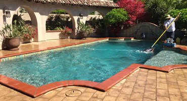 guy cleaning pool